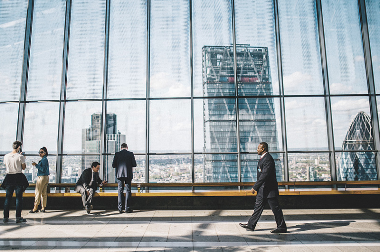 People Walking in Glass Walkway