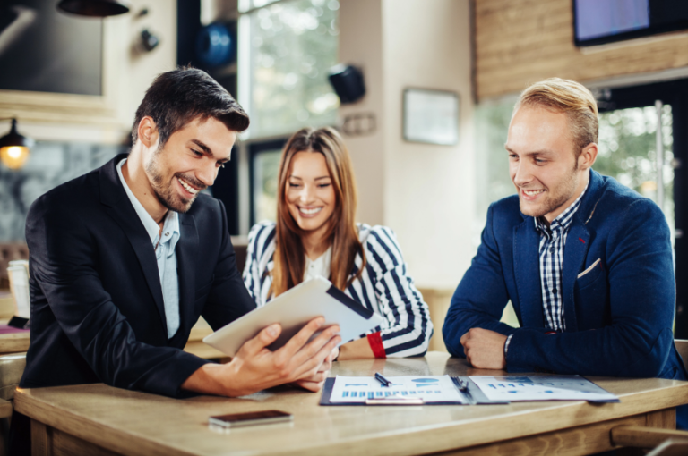 Three Coworkers Looking at Tablet
