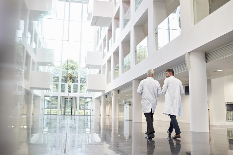 Two Doctors Walking In Building