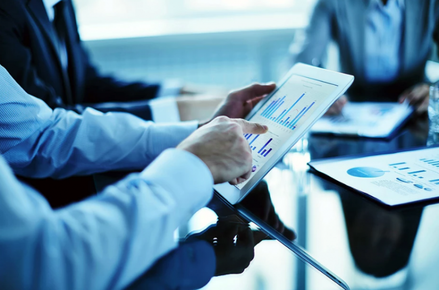 Businessman Pointing to Graph on Tablet